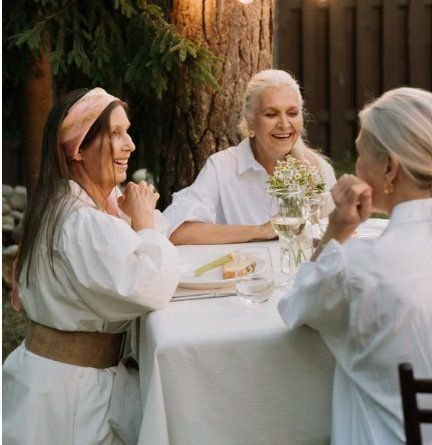Women gathered around a table together, laughing